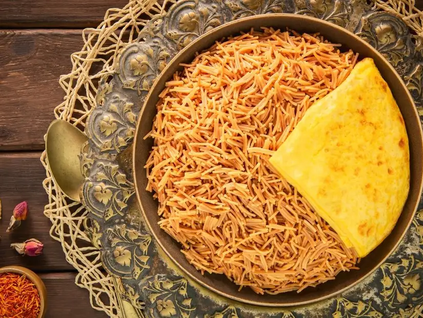 A classic Emirati breakfast of Balaleet, a sweet and savory vermicelli dish served with an omelet, at Al Fanar Restaurant.