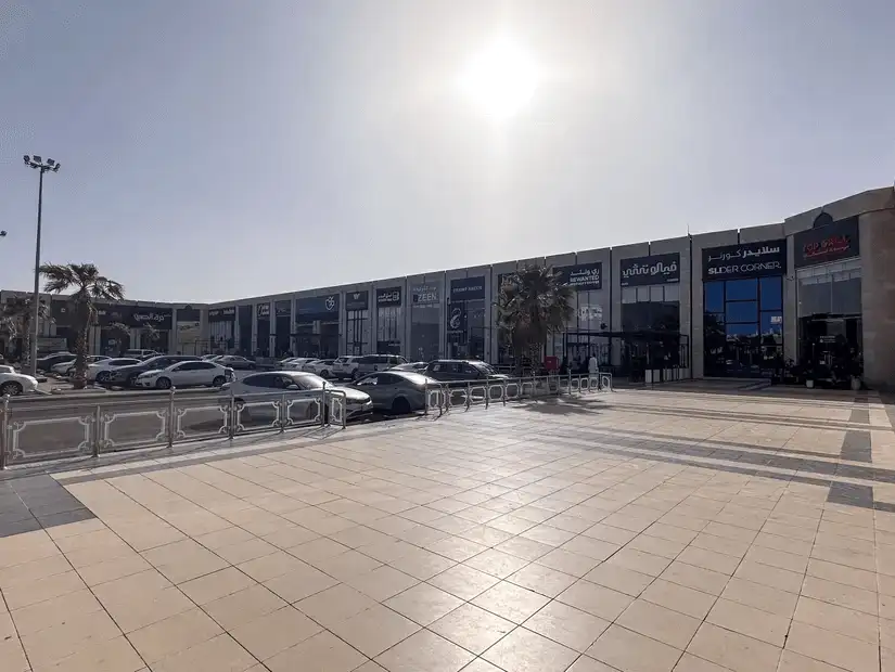 Modern shopping plaza in bright sunlight.