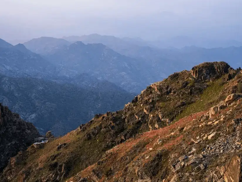 Scenic view of Al Hada's rugged mountain terrain at dusk.