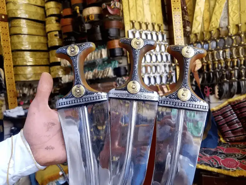 Handcrafted traditional daggers displayed in a shop, showcasing intricate designs and craftsmanship.