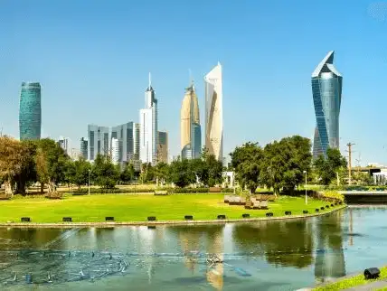 A peaceful scene from Al Shaheed Park, with Kuwait City’s modern skyline in the distance.