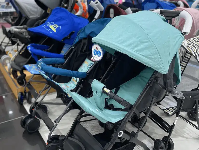 A row of baby strollers on display in a bright, modern store.