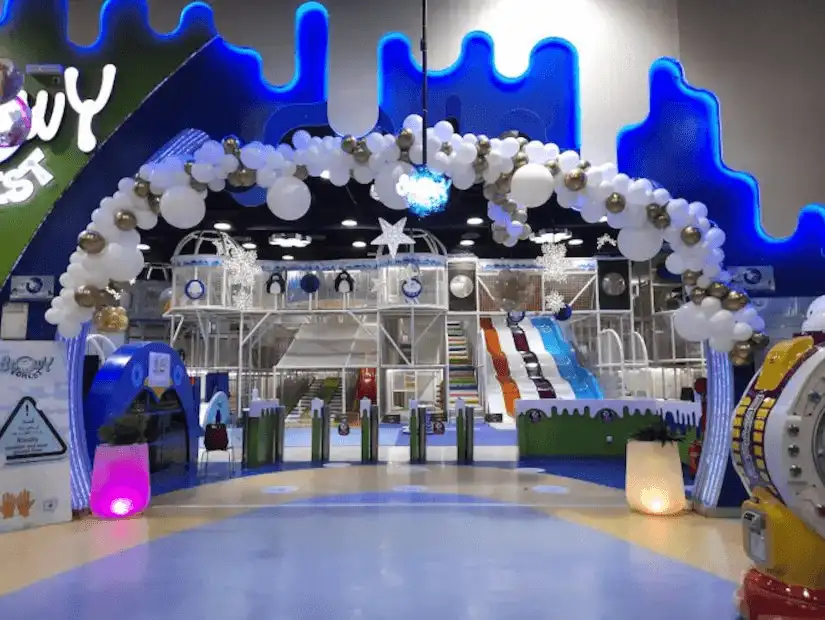 An indoor playground with slides and fun decorations welcomes young adventurers.