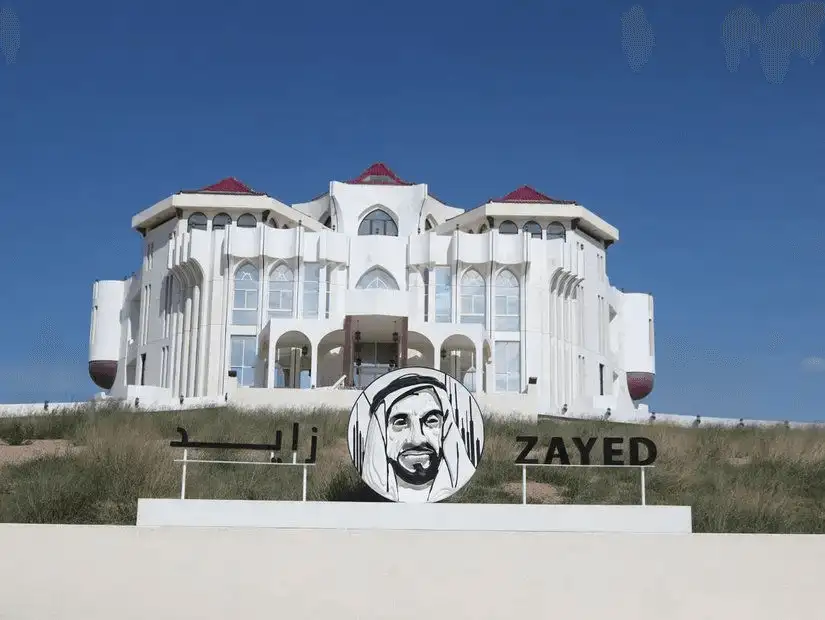 A gleaming white palace with arched windows and red-tipped roofs. 