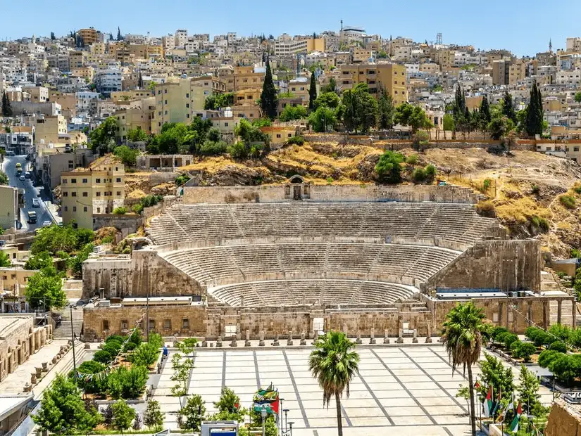 Historical amphitheater surrounded by the vibrant life of a modern city.