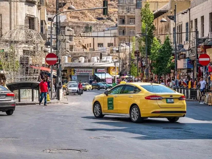 A vibrant cityscape of Amman, Jordan's capital, showcasing its mix of modern and ancient architecture.