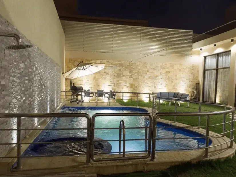 Elegant chalet featuring a private pool and cozy outdoor seating.