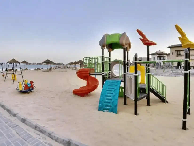 A colorful playground by the beach, perfect for children to enjoy.