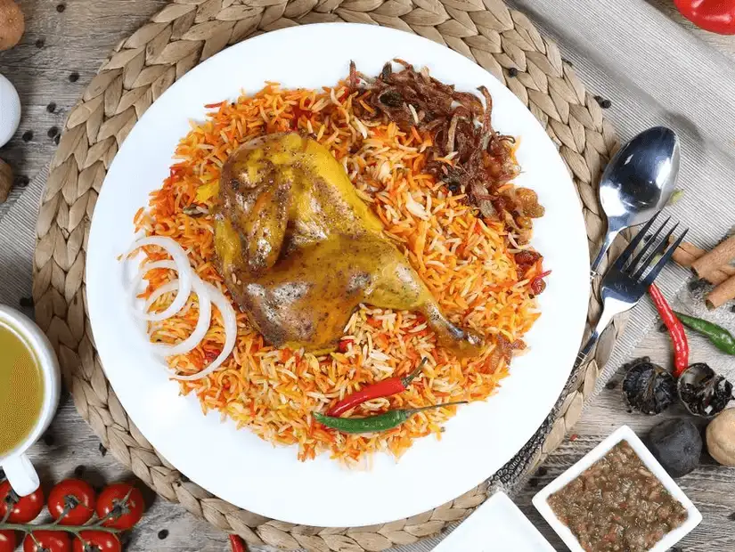 Aromatic chicken biryani, rich in spices and color, garnished with boiled egg.