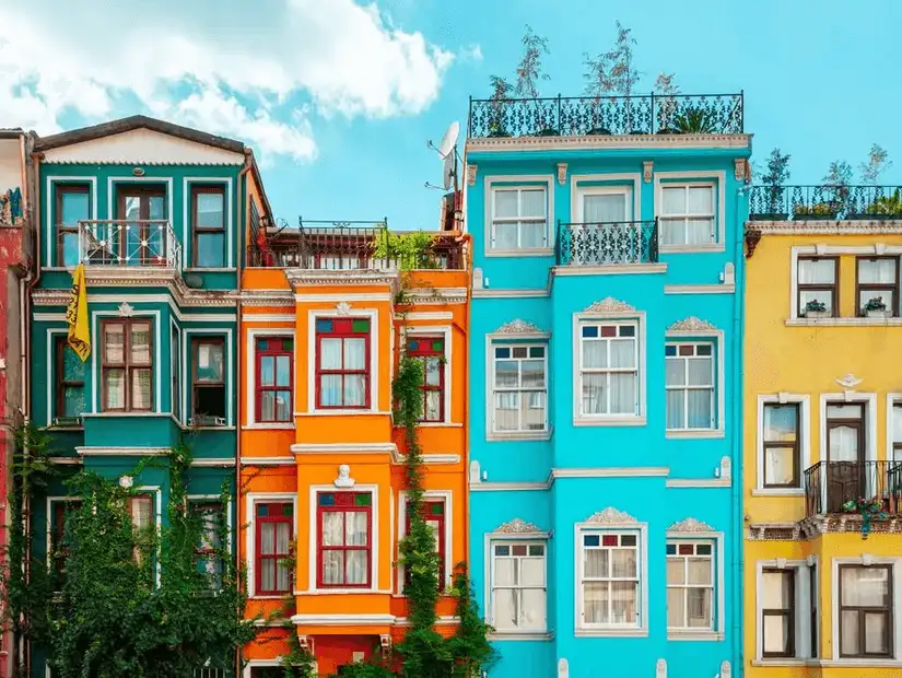 A vibrant neighborhood with colorful buildings and greenery, showcasing a historic area of Istanbul.