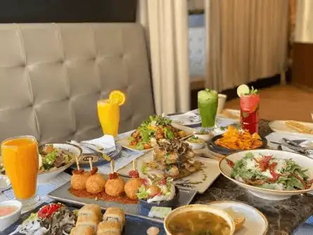 A sumptuous spread of gourmet Middle Eastern cuisine complemented by refreshing beverages, perfect for a luxurious dining experience.