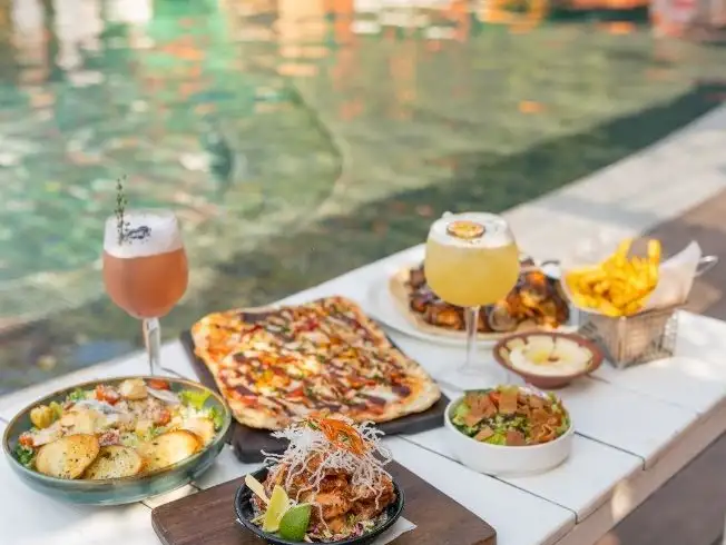 Poolside dining at Barasti Beach with a variety of delicious food and drinks.