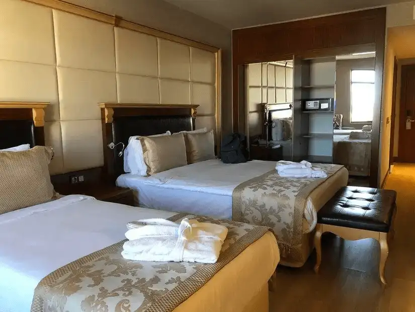 Comfortable hotel room with two beds and modern decor.