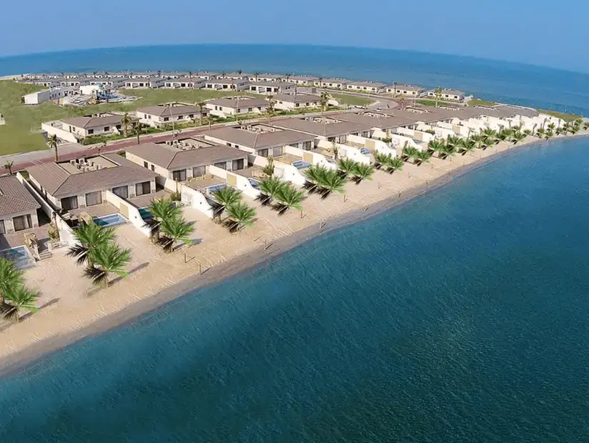 A row of beachfront villas along the shoreline.