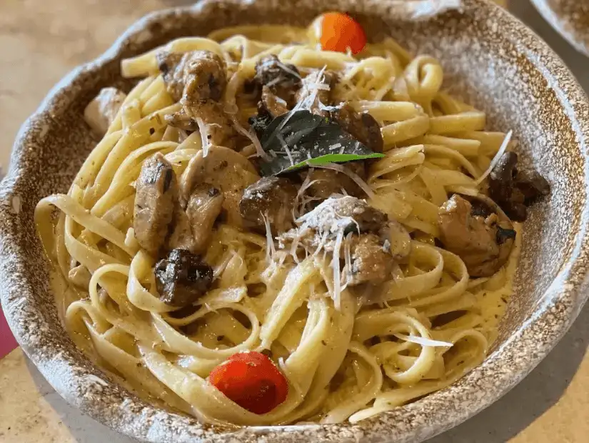 A creamy and savory pasta dish with mushrooms and a touch of fresh herbs.