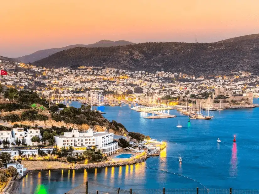 The lively marina of Bodrum illuminated at dusk, showcasing the beauty of the Turkish Riviera.