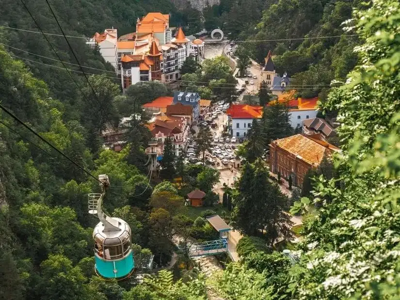 A beautiful natural landscape of Borjomi, with hills covered in trees and a picturesque sky.