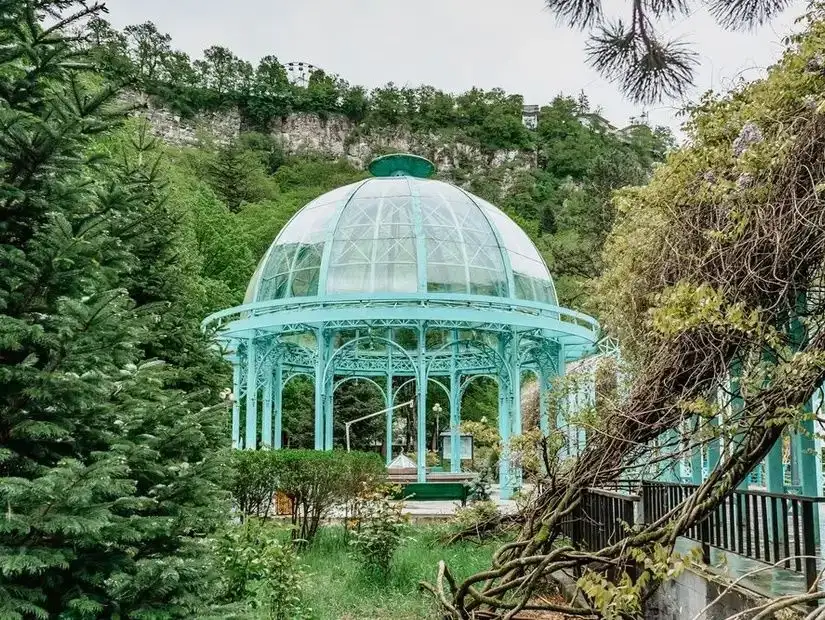 An aerial view of Borjomi, highlighting the town's stunning landscape surrounded by mountains.