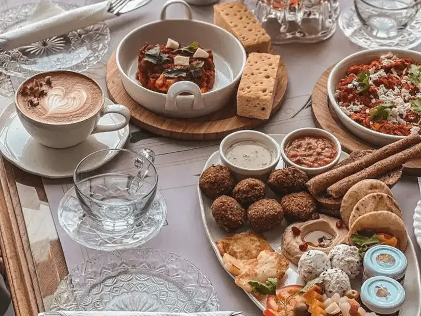 A luxurious spread of Mediterranean dips, falafel, and fresh salads with artisan bread.