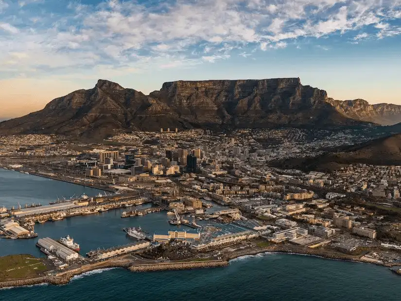 Tranquil view of Cape Town’s mountains bathed in warm sunset light.