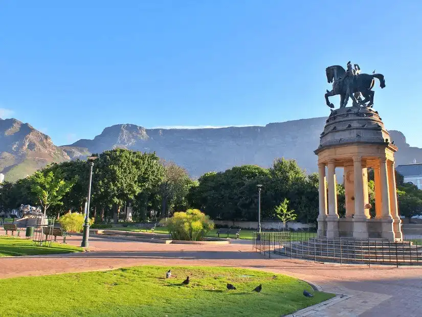 Historical statue surrounded by greenery in Company's Garden, Cape Town.