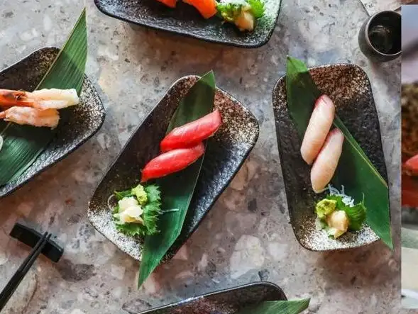 A variety of classic nigiri pieces, beautifully presented on minimalist plates.