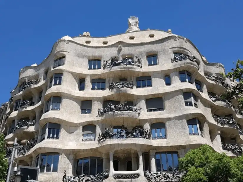 A surreal, undulating stone building designed by Antoni Gaudí in Barcelona.
