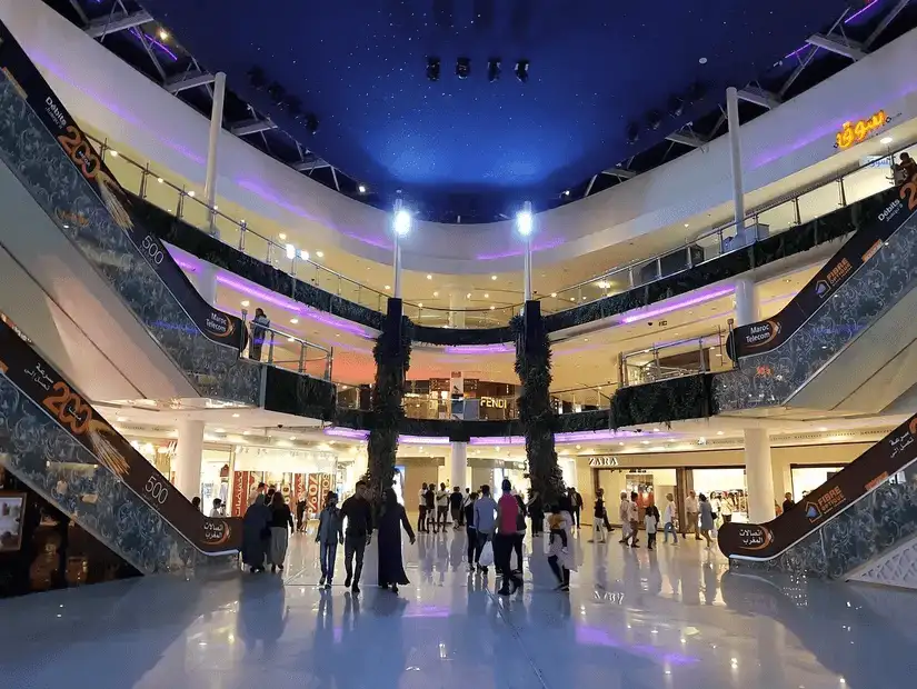 Interior view of Morocco Mall in Casablanca with shoppers and vibrant lighting.