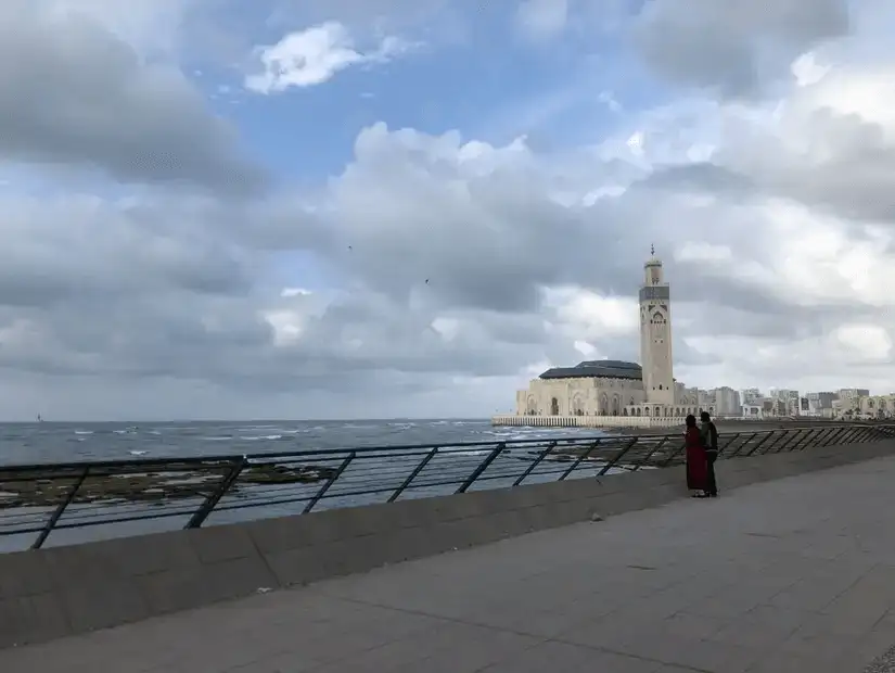 People gathered in front of Casablanca City Hall under a clear blue sky.