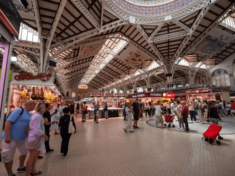 A bustling indoor market filled with local produce, flavors, and vibrant culture.