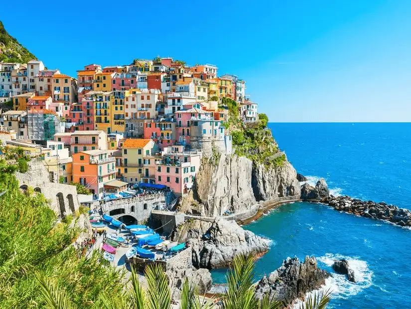 Colorful houses perched on rugged cliffs overlooking the Ligurian Sea in the quaint village of Cinque Terre.