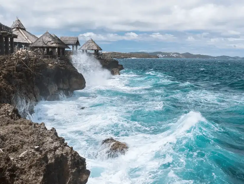 Waves crash against Crystal Cove Island’s cliffs.