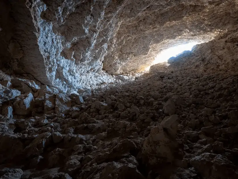 A natural gypsum cave known for its mysterious glow and rocky descent.