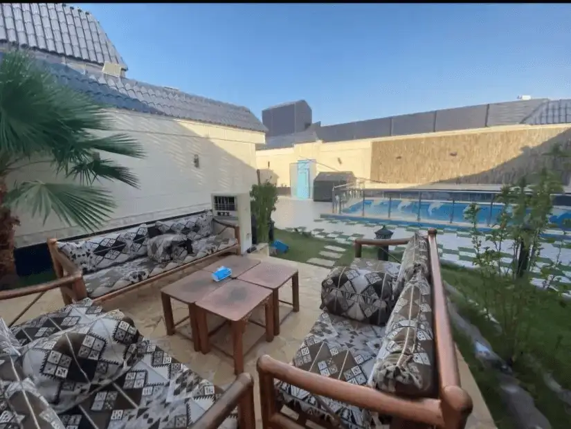 Cozy outdoor seating area next to a private pool.