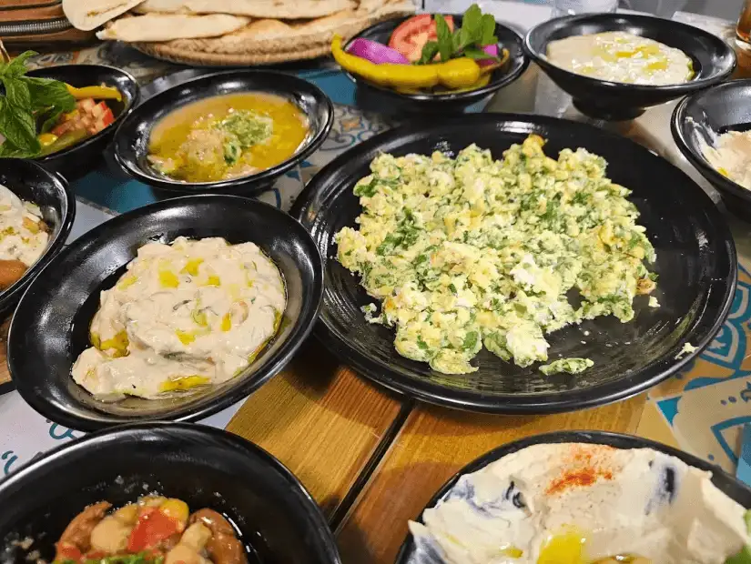 A close-up of a traditional Middle Eastern dessert served on a plate, highlighting its crispy texture and rich flavor, perfect for ending a meal.