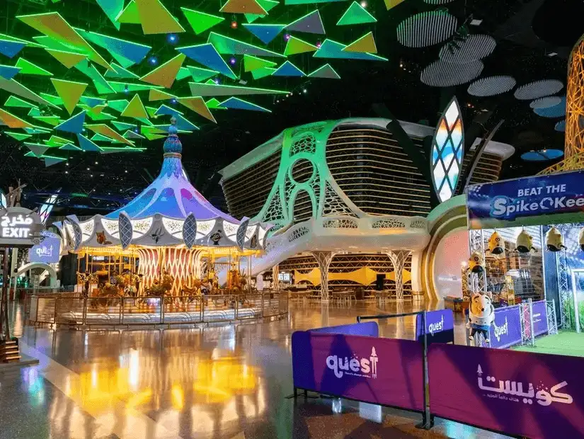An indoor theme park filled with futuristic rides and vibrant lights.