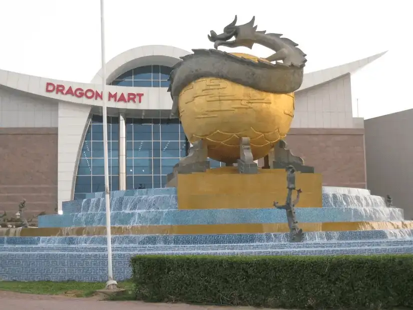 A striking golden dragon sculpture with a fountain at the entrance of Dragon Mart.