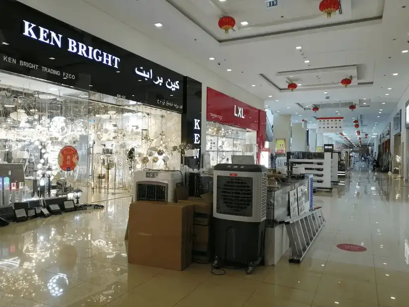 A spacious aisle in Dragon Mart showcasing a variety of shops selling lighting, home appliances, and other goods.