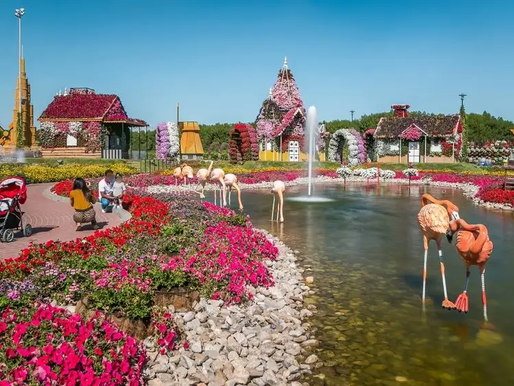 Vibrant flowers and playful flamingo sculptures at Dubai Miracle Garden.