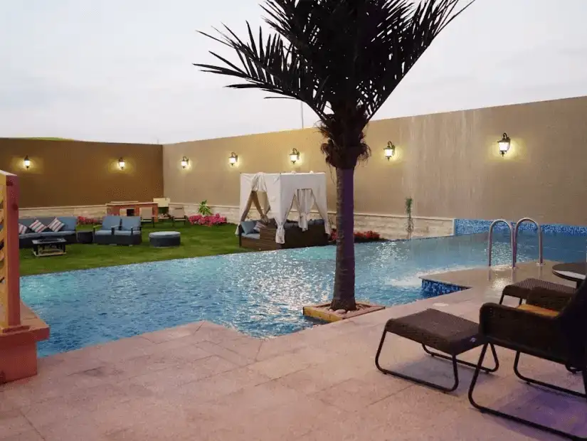 A relaxing poolside lounge with lush greenery and evening lighting.