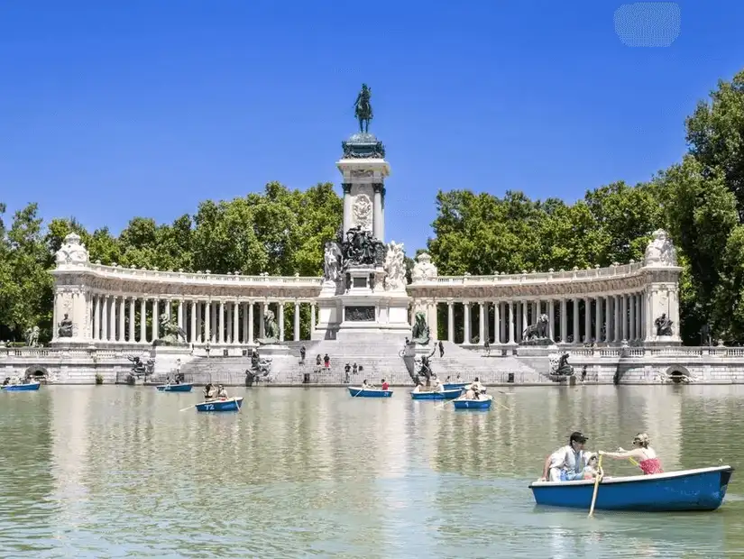A grand city park with rowing boats, monuments, and peaceful green spaces.