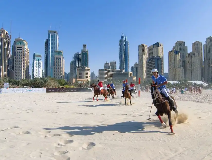 Beach polo with a stunning city backdrop.