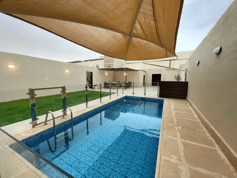 Contemporary chalet with a beautifully lit pool area.