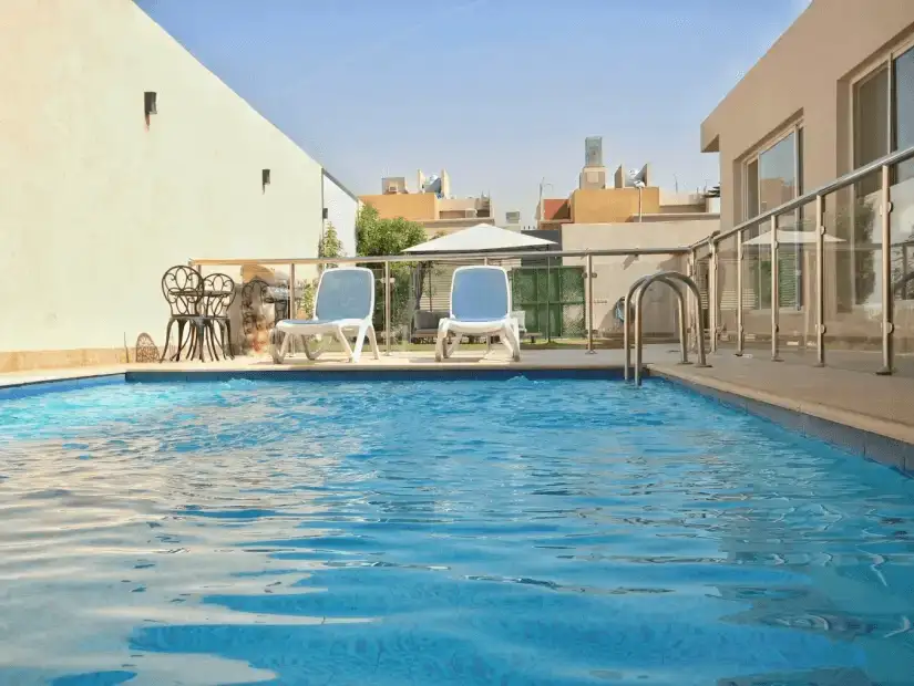 A modern outdoor area featuring a pool with decorative lighting.