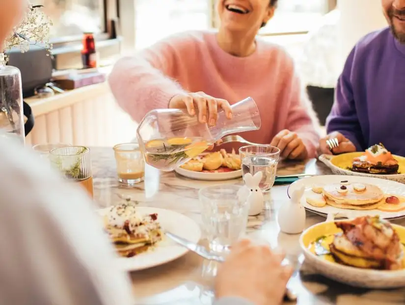 Friends enjoying a joyful brunch together with fresh beverages.