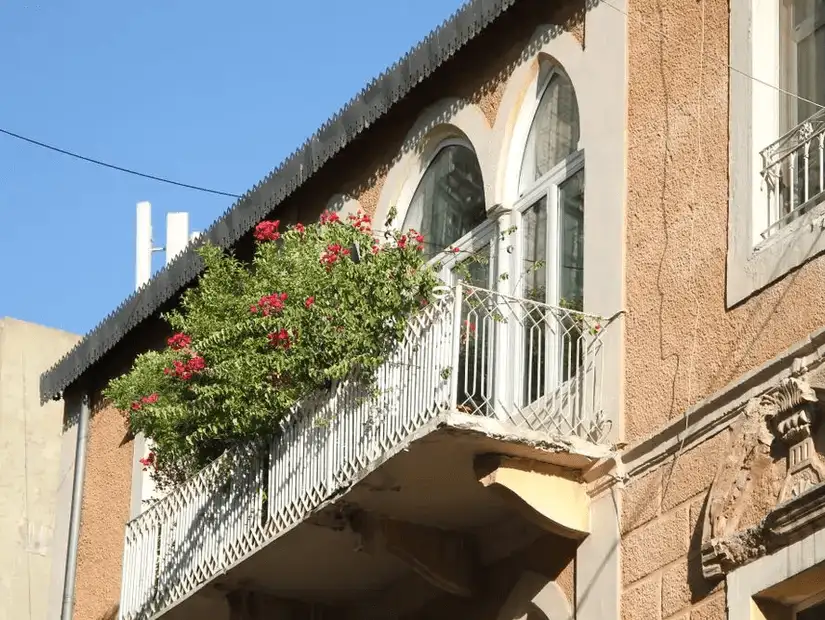 A traditional building with vibrant flower-covered balconies in the artistic Gemmayzeh Street, Beirut.