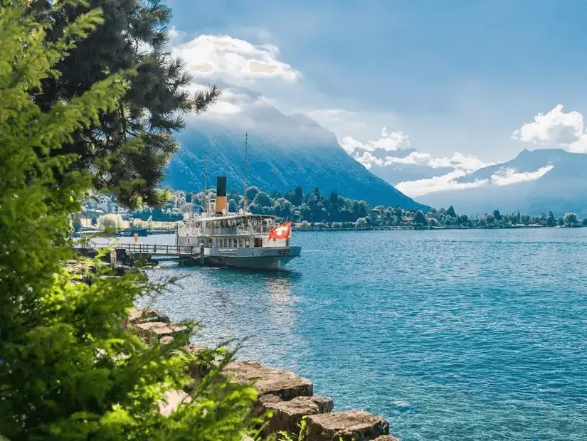 A serene lake view in Geneva with a Swiss steamboat.