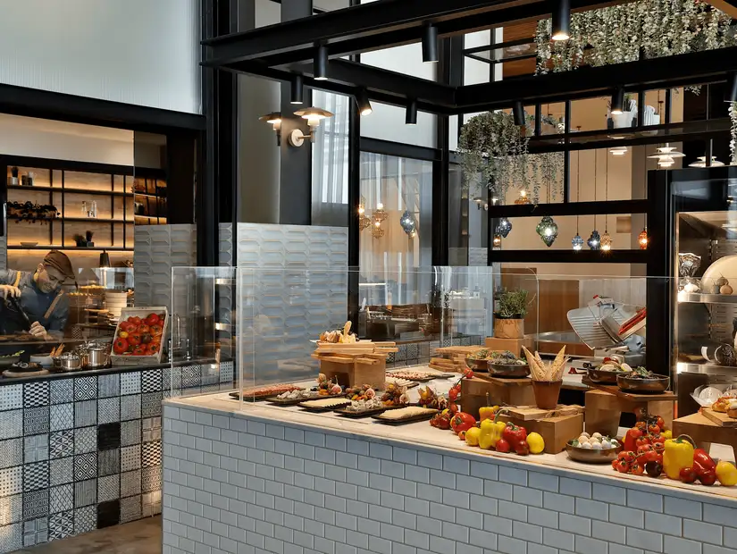 Sleek restaurant interior with glass walls, light fixtures, and vibrant décor.