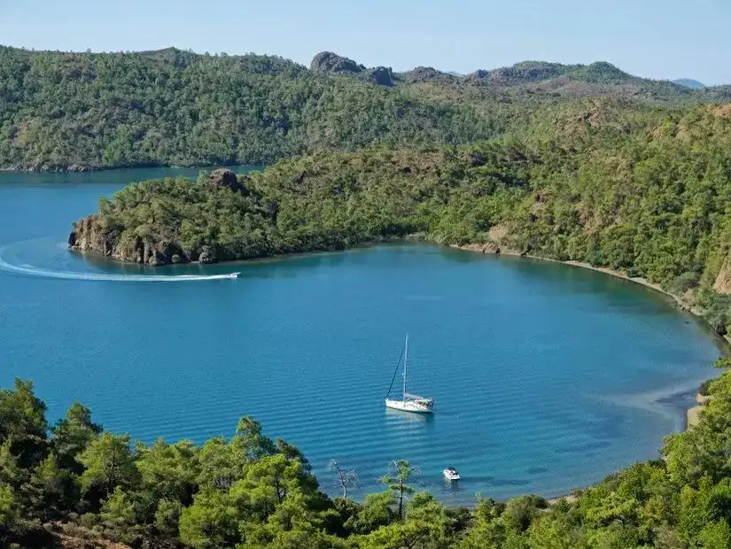 A serene landscape featuring a beautiful bay in Hisaronu, with clear blue waters.