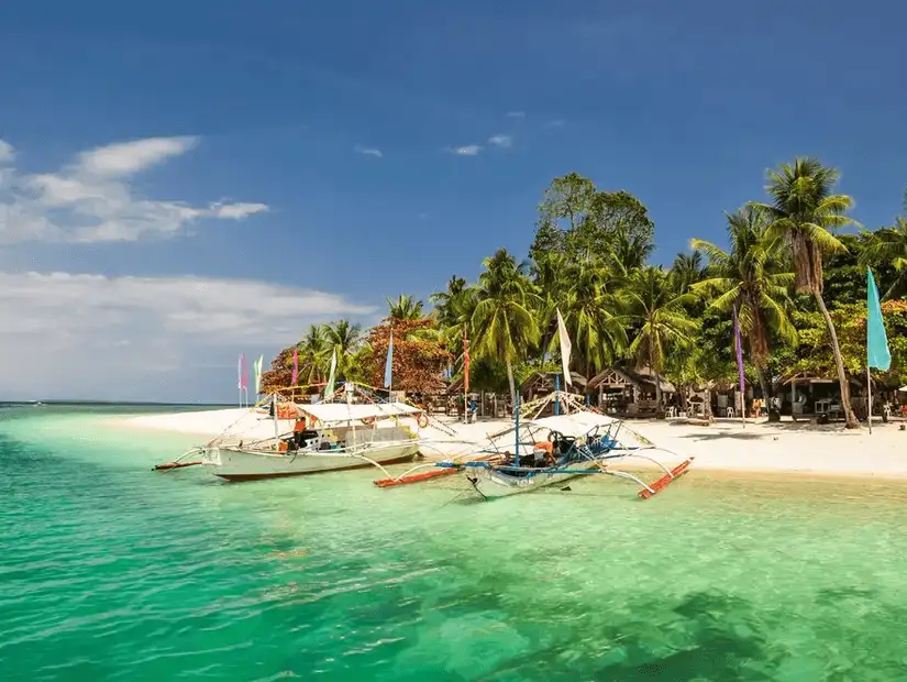 Boats on the clear waters of Honda Bay.